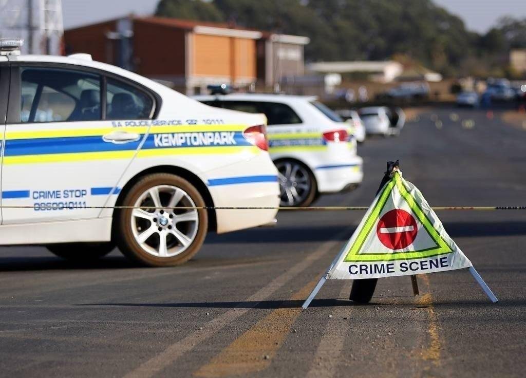 Police vehicles and crime-scene signage in Kempton Park