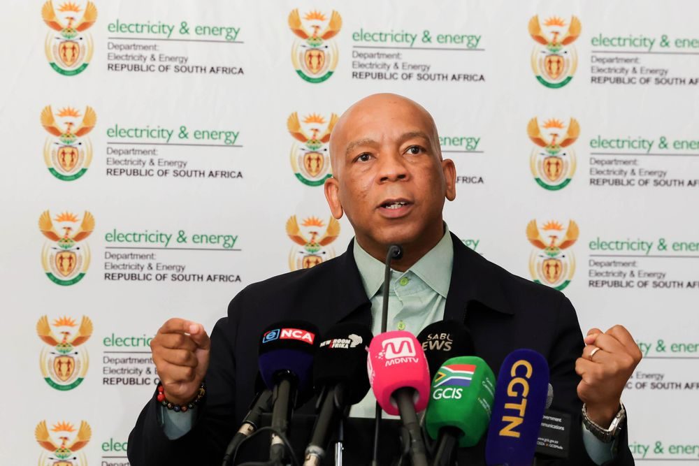 Electricity and Energy Minister Kgosientsho Ramokgopa speaking in front of his department branding at an earlier media briefing