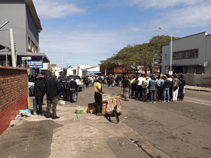 Crowds and police on Che Guevara Road outside Durban’s Refugee Reception Centre during the 7 October 2026 protest
