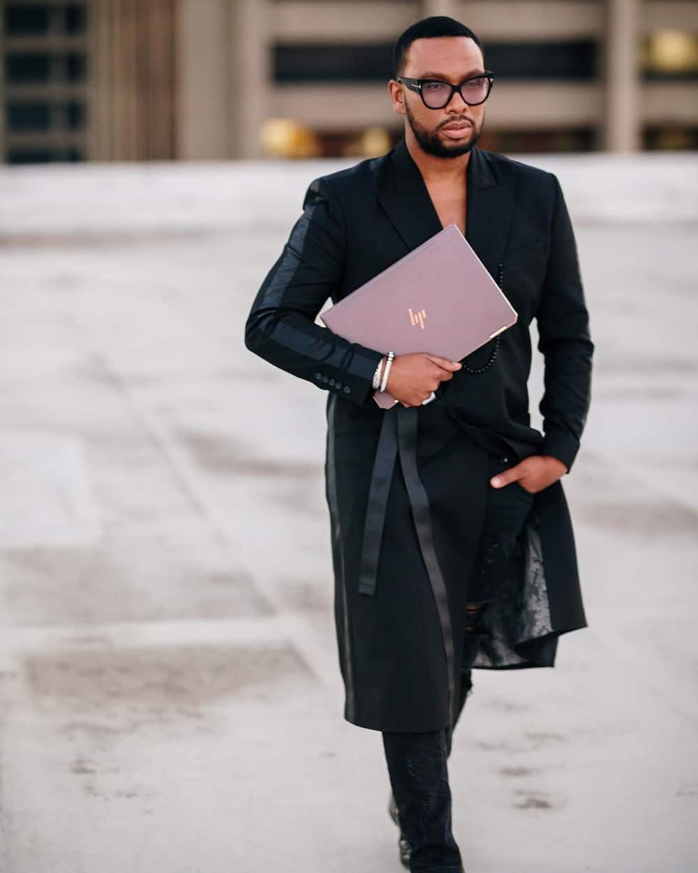 Archive portrait of South African fashion designer David Tlale in a black tailored outfit; not a photograph of the October 2026 SAFW presentation