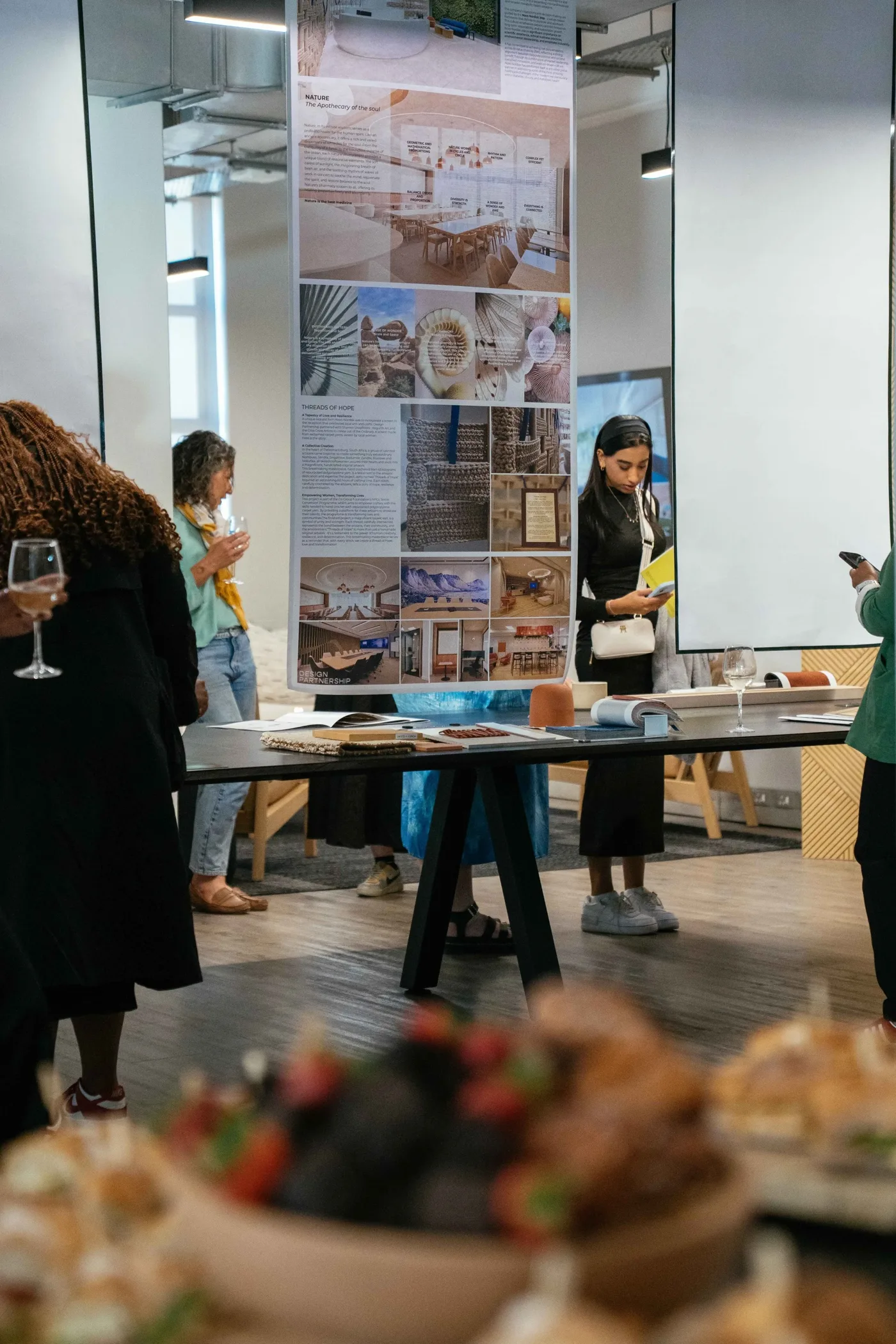 People viewing architectural displays and material samples at an Open Studios event in Cape Town